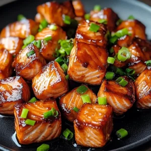 Delicious blackened salmon bites seasoned with spices, served on a plate.