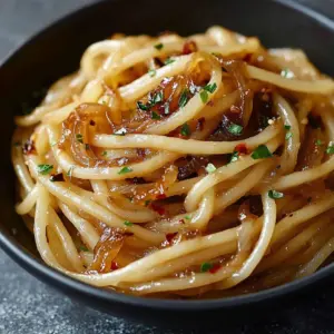 Delicious caramelized onion pasta drizzled with spicy chili oil