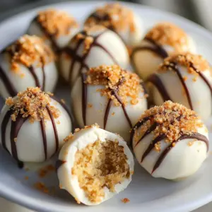 Creamy pumpkin pie cheesecake truffles arranged on a decorative plate.