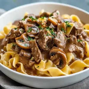 Bowl of slow cooker hearty beef stroganoff with noodles and mushrooms